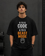 Person wearing a black t-shirt with text and a kettlebell graphic on a dark background